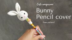 a hand holding a crocheted bunny pencil cover with the text, cute amigurmi bunny pencil cover free pattern