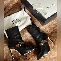 The Gucci Nappa Leather Sylvie Ankle Heeled Boots In Black Is Crafted In A Smooth Soft Black Leather In Italy. This Ankle High Boot Features A Green And Red Webbed Crossgrain Strap With Antique Gold Tone Buckle And Stiletto Heel. Side Zip Closure Size 37.5 Product Number 475653 Heel Height: 11 Cm / 4 In Notes: Slight Mark On Bottom Of Heel, Overall Leather Looks Very Good Worn Like 3-4 Times Only!!! ** Im A 7.5 And They Feel A Bit Snug So I Suggest This For A Size 7 Or 7.5 With Narrow Feet. Paid Retail Over $1200 With Tax. Comes In Original Box, Dust Bags, Care Booklet, Heel Tap. Buckle Booties, Heel Tap, High Ankle Boots, Gucci Leather, Green And Red, Best Wear, Gucci Shoes, Heeled Ankle Boots, Nappa Leather