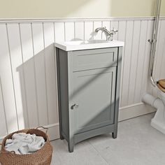 a white toilet sitting next to a sink in a bathroom