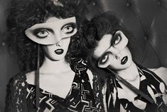 two women with black and white make - up on their faces are posing for the camera