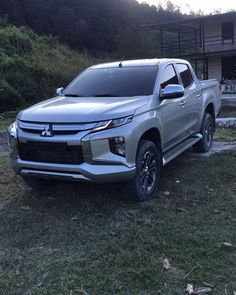 a silver truck parked in front of a house