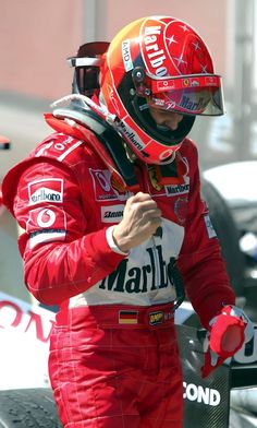 a man in a red racing suit and helmet