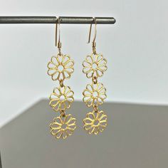 "Flower Earrings Linear Earrings Drop Earrings Dangle Earrings Bohemian Earrings Filigree Earrings Dainty Earrings Lace Earrings Gift for her These beautiful linear lightweight Daisy earrings have a delicate blend of femininity and edge. Light enough for every day yet filled with elegant beauty for your special occasions. Material: Gold Plated Brass / Silver Plated Brass Length - 2\" Width: 6/16' Earring Backings: Each pair of earrings includes a set of clear rubber stoppers. All my jewelry come Metal Pierced Flower Earrings, Delicate Nickel-free Dangle Flower Earrings, Adjustable Drop Flower Earrings, Hypoallergenic Metal Flower-shaped Earrings, Dainty Dangle Flower Earrings, Gold Dangle Flower Earrings, Delicate Pierced Flower Drop Earrings, Dainty Dangle Flower Earrings With Ear Wire, Gold Drop Flower Earrings For Pierced Ears