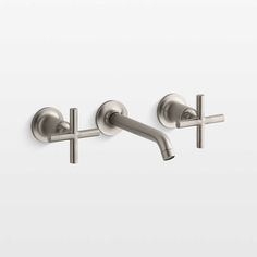 two stainless steel wall mounted faucets with cross handles