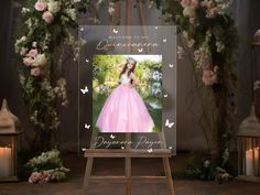 an easel with a photo of a woman in a pink dress