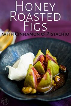 honey roasted figs with cinnamon and pistachio in a black bowl on a purple table cloth