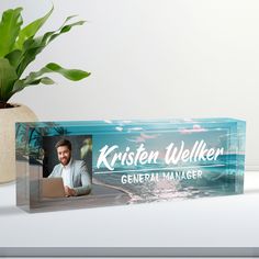 a blue box with a picture of a man on it and a potted plant next to it