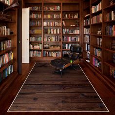 an empty chair in the middle of a room with bookshelves full of books