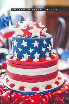 a red, white and blue cake with stars on top is sitting on a table