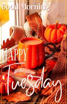 a cup of coffee sitting on top of a table next to autumn leaves and pumpkins