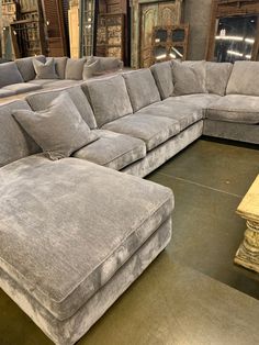 a large sectional couch in a store with pillows on the bottom and back cushions down