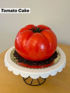 a large tomato sitting on top of a cake