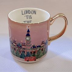 a pink and gold coffee cup with the words london, its the city on it