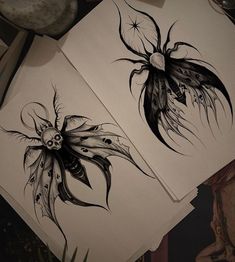 two drawings of flowers on paper next to each other