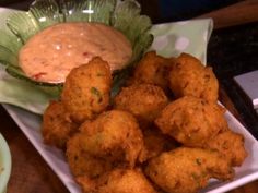 some fried food on a plate with dipping sauce