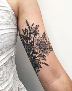 a woman's arm with flowers on it