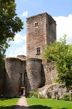 an old castle with a walkway leading to it