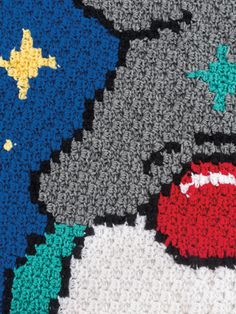 a crocheted rug with an image of a woman's face on it