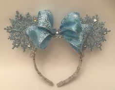 a blue and silver headband with snowflakes on it's side, attached to a white wall