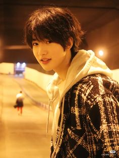 a young man standing in front of a skateboard ramp with his eyes wide open