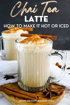 two mugs filled with cinnamon spice latte on top of a wooden board and surrounded by cinnamon sticks