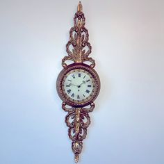 an ornate clock is hanging on the wall