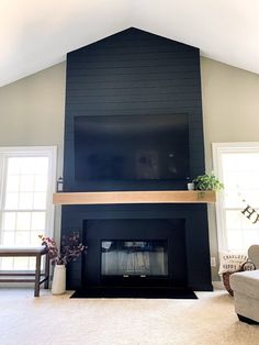 a living room with a black fireplace and white carpet