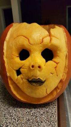 an orange pumpkin with a face carved into it