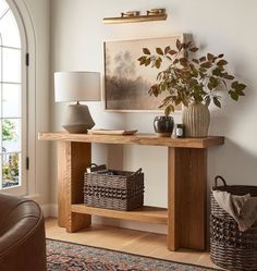 a living room with a couch, table and lamp in it's centerpiece