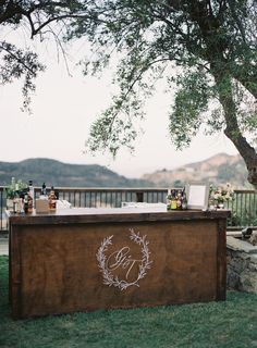 an outdoor bar is set up under a tree