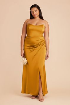 a woman in a mustard colored dress