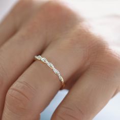 a woman's hand with a diamond ring on it