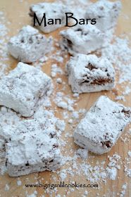 some brownies are covered in powdered sugar on a cutting board with the words man bars above them