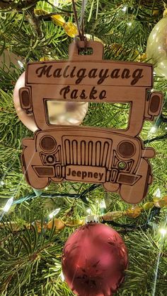 an ornament hanging from the christmas tree that says malaysia pako on it