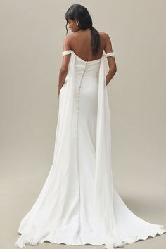 the back of a woman in a white wedding dress