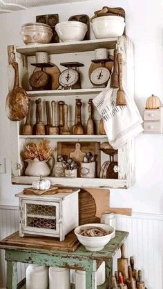 an old fashioned kitchen with lots of dishes and utensils