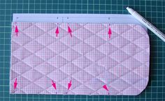 a piece of fabric with pink arrows on it next to a marker and ruler,