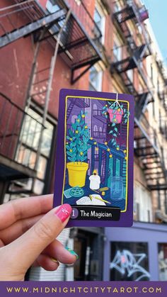 the magician tarot card is held up in front of a building with fire escapes