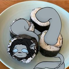 three sushi rolls on a plate with an image of a woman's face