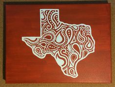 a wood block with an image of the state of texas in white and red on it