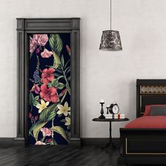 a bed room with a neatly made bed and a flowered door to another room