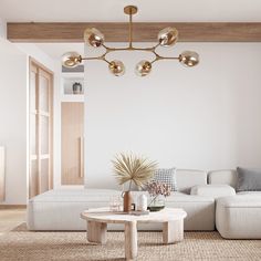 a living room filled with furniture and a chandelier hanging over the top of it