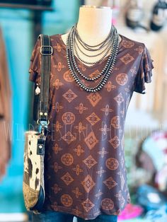 ALL SALES FINALUnleash your inner fashionista with the playful and quirky Beverly Hills Top! This stylish brown top features a tan aztec design and charming ruffle sleeves, adding a touch of fun to your wardrobe. Perfect for adding a unique and trendy touch to any outfit. 94% polyester 6% spandex SIZE CHEST LENGTH SLEEVE WIDTH SLEEVE LENGTH XS 18" 24" 9" 7" S 19" 25" 9" 8" M 20" 25" 9" 8" L 21" 25.5" 9" 9" XL 22" 26" 10" 9.5" 2X 24" 26" 10" 10" 3X 25.5" 26.5" 10.5" 10.5" Deodorant Stains, Aztec Design, Aztec Designs, Brown Top, Ruffle Sleeves, 8 M, Beverly Hills, Length Sleeve, Sleeve Length