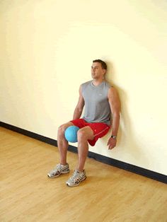 a man sitting on top of a blue ball