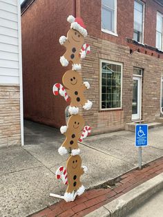 a street sign with gingerbreads and candy canes on it in front of a brick building