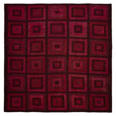 a red rug with square and rectangles on the bottom, in different colors