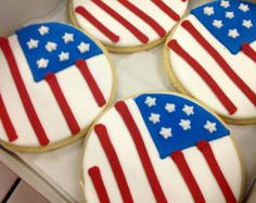 four decorated patriotic cookies in a box