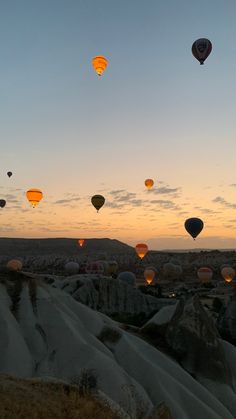 many hot air balloons flying in the sky