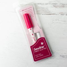 a pink and white pen in its packaging