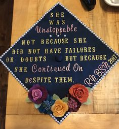 a decorated graduation cap with writing on it and flowers around the edges that says she was unstopable not because she did not have failure